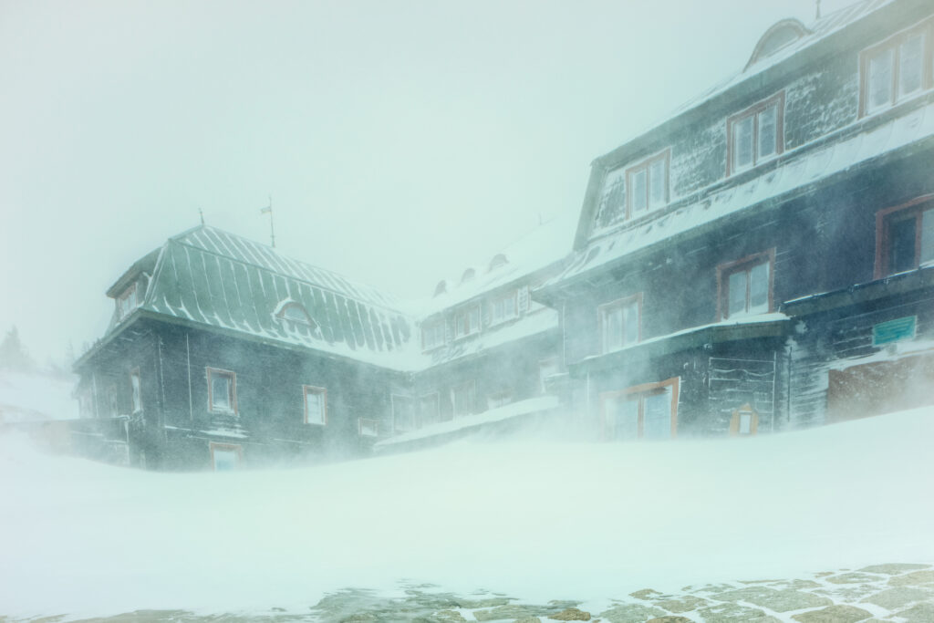 Snow-covered buildings in a winter storm, highlighting the importance of standby generators for safety and comfort during power outages.